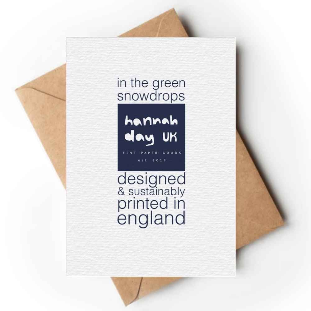 Reverse of a white textured paper greeting card with navy blue text and a dark blue brand block reading 'hannah day uk', layered over a brown kraft envelope on a white background.