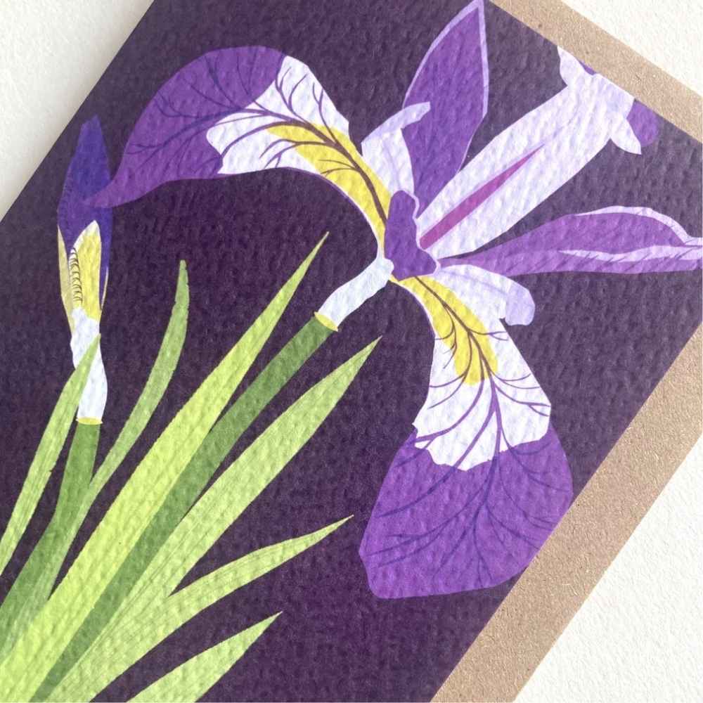 A close-up of a textured art print or card featuring a stylized purple and white iris flower with green leaves on a dark purple background, with a beige border visible along the right edge.