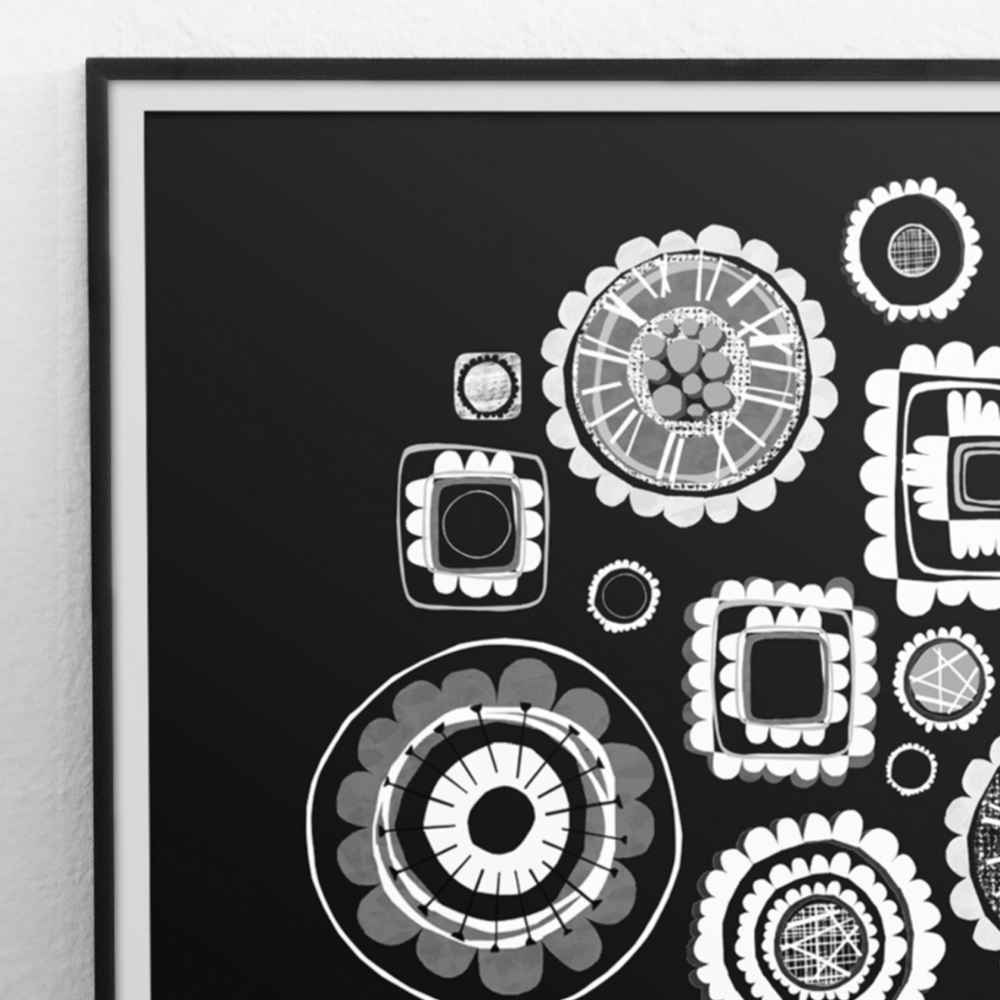 Detail of a black and white art print featuring various circular, square, and oval geometric patterns, displayed on a light-colored wall. Flowers in amid century vase. 