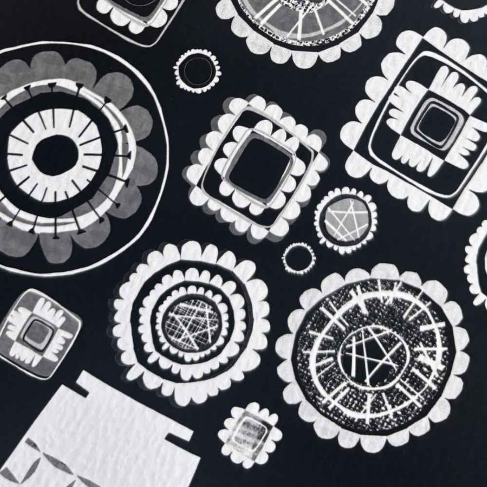 Black and white patterned print featuring a repeating design of stylized circular and square floral motifs.