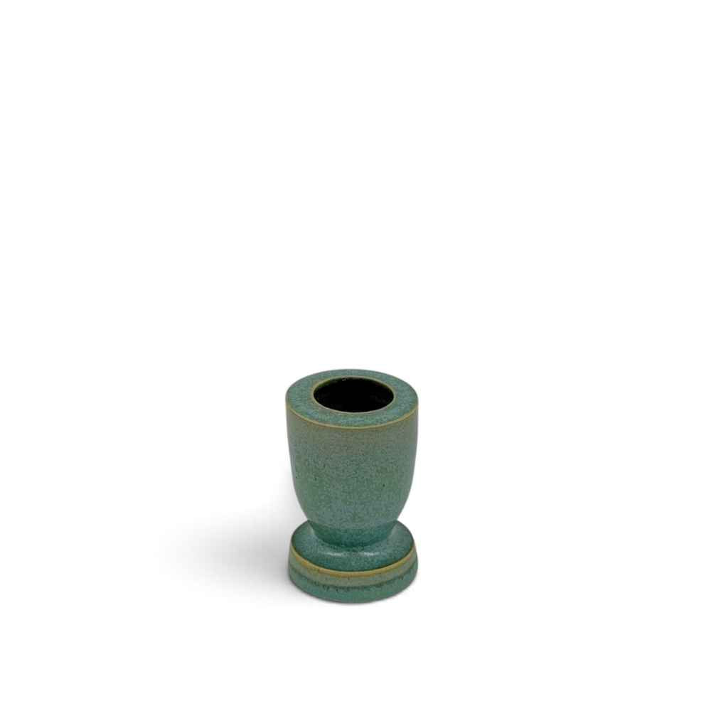 Green egg cup shaped ceramic candle holder