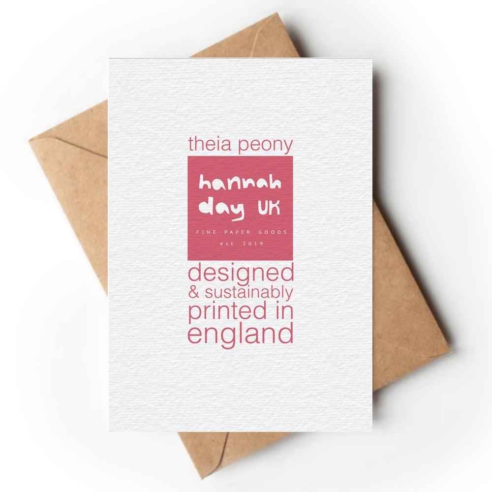 A white textured greeting card with pink text reading 'theia peony', a pink square logo block reading 'hannah day uk', and 'designed & sustainably printed in england', shown with brown kraft envelopes on a white background.